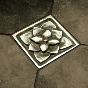 Foundry Art Lotus 3-inch metal accent inset tile dark gray limestone floor installation