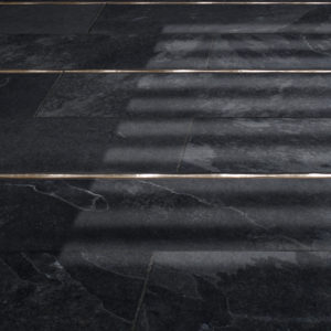 Bronzework Studio Classic Flowing metal accent liner tile with black stone