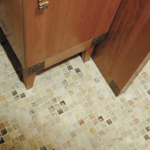 Foundry Art Lotus knob and various 1-inch metal accent inset tiles with stone mosaic floor