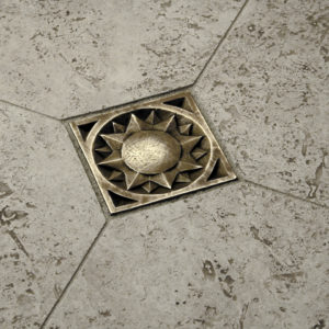 Foundry Art Sun metal accent tile gray travertine limestone floor installation
