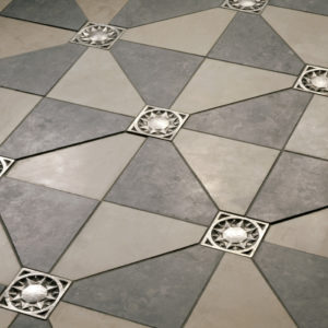 Foundry Art Sun metal accent inset tile light and dark gray limestone floor installation