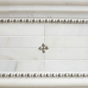 Bronzework Studio Classic Blooming Leaf .63-inch inset and Roman metal accent liner tiles with white marble