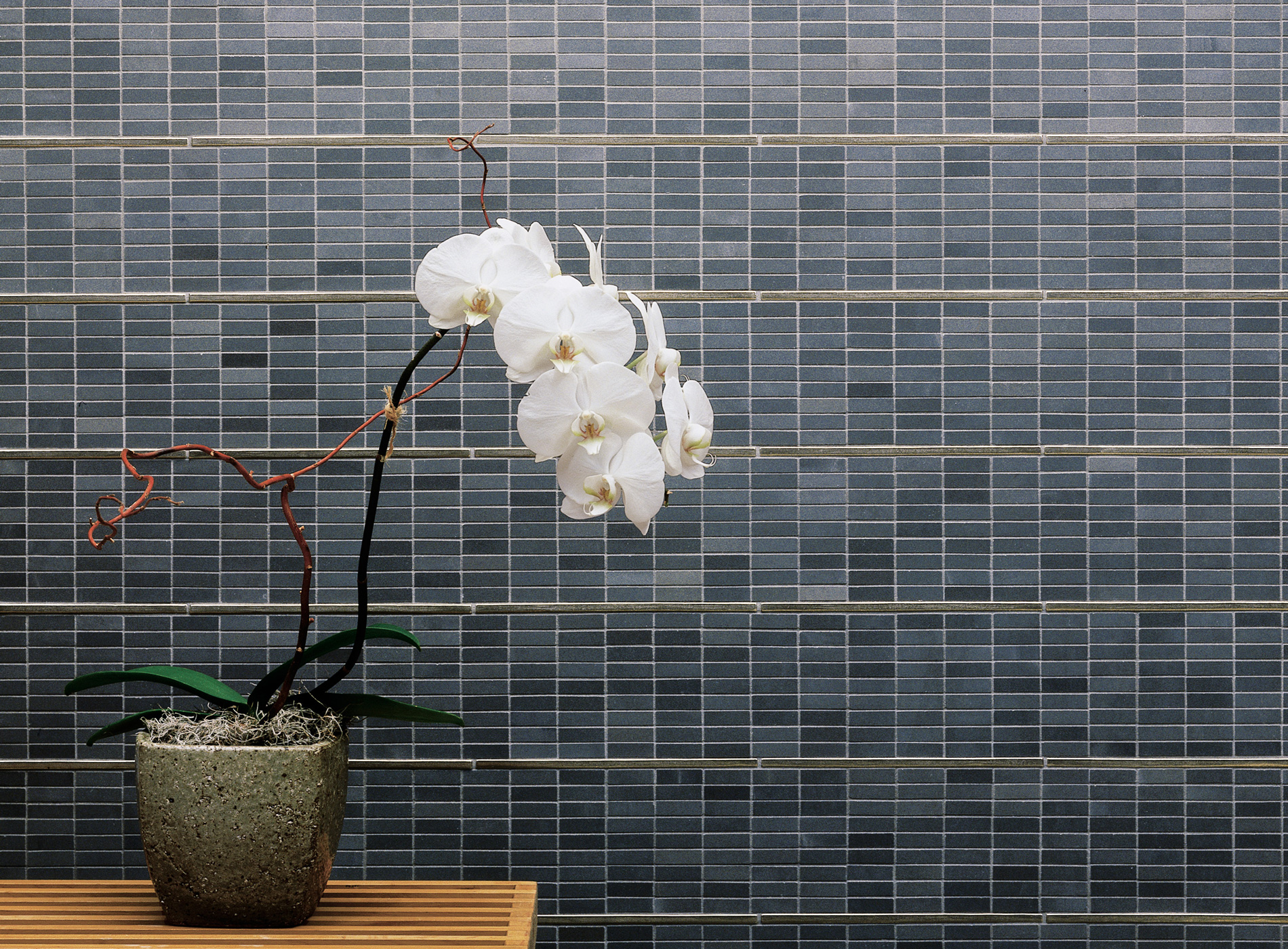 Foundry Art Straight Line metal accent liner tile with blue and gray stone wall installation