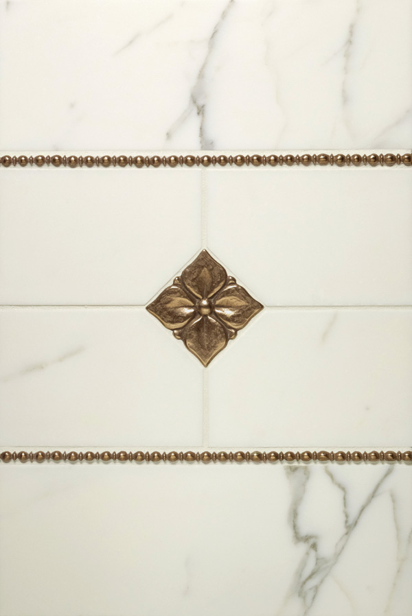 Bronzework Studio Classic Blooming Leaf 2.5-inch inset and Roman metal accent liner tile with white marble