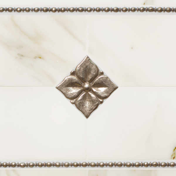 Bronzework Studio Classic Blooming Leaf 2.5-inch inset and Roman metal accent liner tiles with white marble